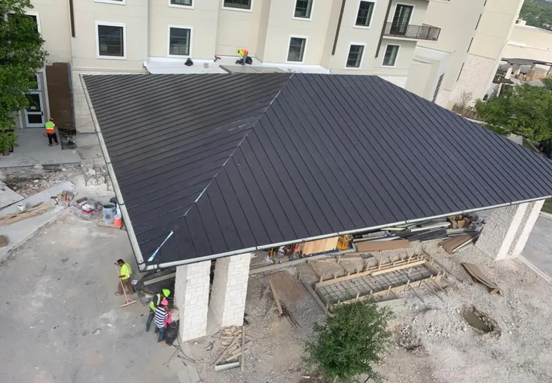 Metal roofing installation team working on a commercial building in Fairfield
